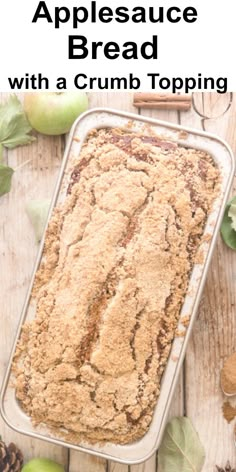 applesauce bread with a crumb topping in a pan on a wooden table