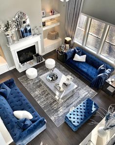 an aerial view of a living room with blue couches