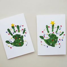 two cards with hand prints on them, one is green and the other is red