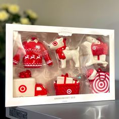 an assortment of red and white ornaments in a box