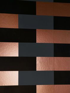 an abstract painting with black, brown and silver stripes on the wall in front of it