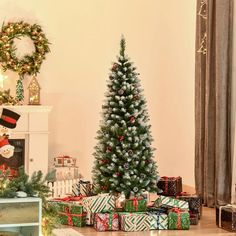 a christmas tree surrounded by presents in front of a fireplace