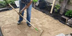 a man is shoveling dirt in his yard