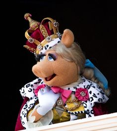 the miss piggy doll is wearing a tiara