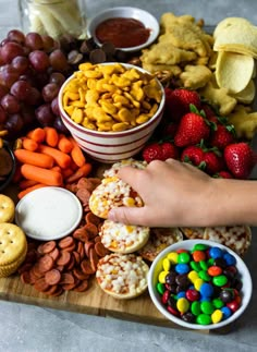 a wooden tray topped with lots of snacks