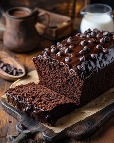 there is a chocolate cake with chocolate chips on the top and one slice cut off