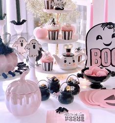 a table topped with cupcakes and halloween decorations