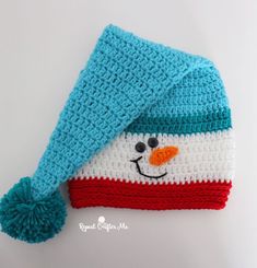 a crocheted hat with a snowman face on it