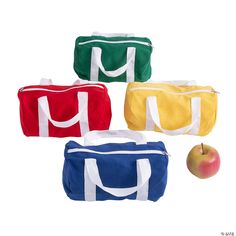 four different colored duffel bags with an apple