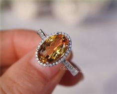 Gorgeous 8*12 mm  oval Citrine ring, made with 925 sterling silver, plated with white gold.Main Stone: 8*12 mm Natural CitrineSide Stone: CZNeed other size please contact.CS0100 Yellow Oval Topaz Ring With Halo Setting, Oval Orange Topaz Ring With Center Stone, Orange Oval Topaz Rings, Oval Orange Topaz Gemstone Ring, Oval Orange Rings With Accent Stones, Orange Oval Rings With Accent Stones, Yellow Gemstone Jewelry, Citrine Engagement Ring, Birth Stones