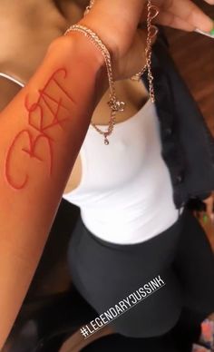 a woman is showing off her arm with the word crazy on it's side