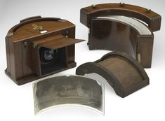 an old fashioned wooden camera and other items