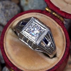 a diamond ring sitting on top of a wooden box