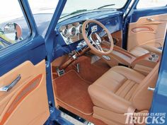 the interior of an old blue car with tan leather seats