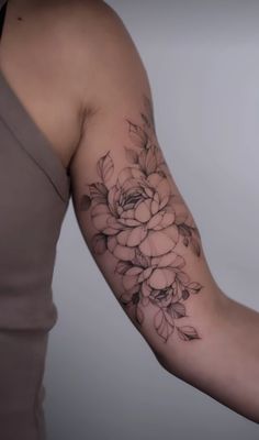 a woman with a flower tattoo on her arm