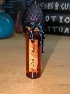 a glass bottle filled with liquid sitting on top of a wooden table