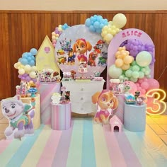 a birthday party with balloons, toys and decorations