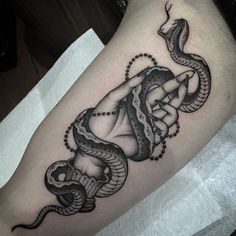 a black and white tattoo with a snake on it