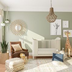 a baby's room with green walls and white furniture