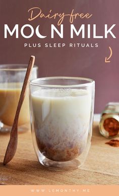 a glass filled with milk next to cinnamon sticks