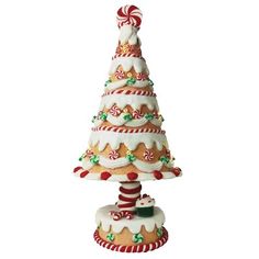 a ceramic christmas tree with candy canes on top