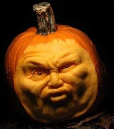 a pumpkin with an evil face carved into it