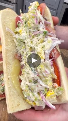 two hotdogs with coleslaw, mustard and ketchup on them