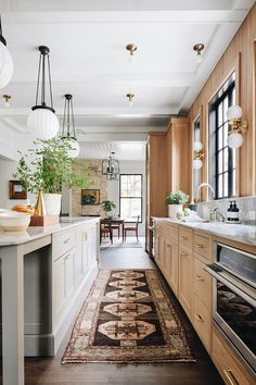 a kitchen with wooden cabinets and an area rug