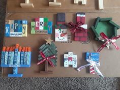 several different types of wooden letters and decorations on a cardboard box with magnets attached to them