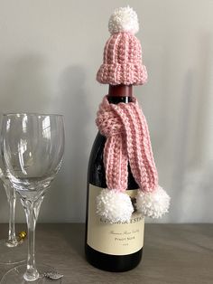 The perfect way to dress up a bottle of wine, or any bottle for that matter. This rosy pink and white pom pom scarf and hat is the perfect décor for Valentine's Day. Makes a great hostess gift too. Color: Pink and white Other colors are available. All pieces in my store are handmade by me, never outsourced. Crocha Cone Hat For Wine Bottel, Crochet Wine Bottle Hat And Scarf, Bottle Cozies, Scarf And Hat, Pompom Scarf, A Bottle Of Wine, Crochet Collar, Hat And Scarf, Bottle Of Wine