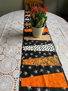 a potted plant sitting on top of a table next to a white doily