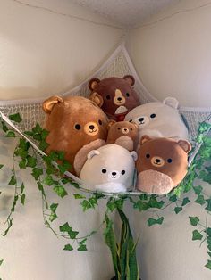 there are many stuffed bears in the corner of this room with ivy on the wall