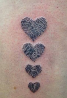 a woman's back with three hearts on it