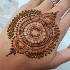 a woman's hand with a hendi design on it