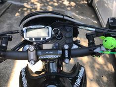 a close up view of the handlebars on a motorbike with a digital clock