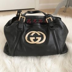 Authentic 100%~ Gucci Black Leather Shoulder Bag With Gold Gg Logo Statement Piece..The Leather Is As Soft As Butter. Vintage, Gorgeous Bag With Gucci Duster..Made In Italy..The Black, Green And Red Gg Lining Inside..A Generous Inside Zip Pocket, 5 Gold Ball Feet On Bottom...This Has To Be One Of My Favorite Handbags That Ever Owned. It's The " Cadillac" Of Handbags. This Beautiful Bag Is In Mint Condition...Inside And Out..Only Worn A Handful Of Times..Always Kept In Sleeper..Extremely Well Car Black Leather Shoulder Bag, Favorite Handbags, Gg Logo, Gorgeous Bags, Green And Red, Gucci Black, Beautiful Bags, Black Green, Cadillac