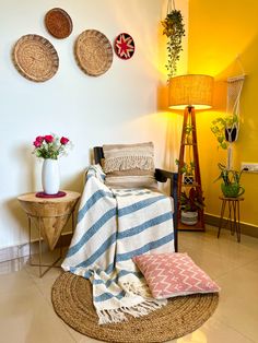 a living room with yellow walls and wicker furniture on the floor, flowers in vases