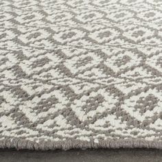 a gray and white rug on the ground