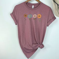 ♡ Check out the photos when you select a color to see what your shirt will look like in your chosen color! ♡ Stone Orchard has the perfect boho shirts for any birthday gift, Mother's Day gift, Christmas gift, or Treat-Yo-Self Gift All of our shirts are made with the highest quality materials and are soft, stretchy and comfortable for every day wear! Designs are inspired by nature- so you'll find lots of fun and trendy organic textures, earth tones and minimalist beauty ❀ ♡ SHIRT SIZING All of ou Pink Short Sleeve Shirt With Plant Print, Pink Cotton Tops With Plant Print, Pink Cotton Shirt With Floral Embroidery, Relaxed Fit Short Sleeve Shirt With Sunflower Print, Relaxed Fit Sunflower Print Short Sleeve Shirt, Spring Short Sleeve Shirt With Sunflower Print, Spring Cotton Shirt With Sunflower Print, Spring Relaxed Fit Shirt With Sunflower Print, Women Nature