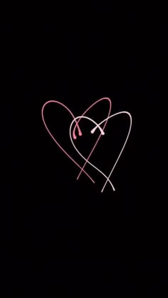 two hearts with arrows drawn on them in the dark