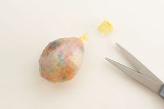 a pair of scissors are next to a gummy bag with yellow and blue sprinkles on it