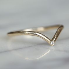 a gold ring with a diamond on it