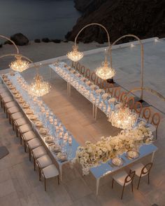 an aerial view of a long table set up with candles and flowers on the tables