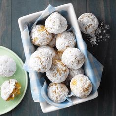 powdered sugar covered donuts in a bowl on a table