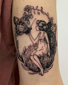 a woman with two butterflies on her arm