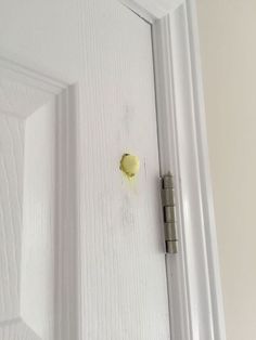 an open door with a yellow piece of paint on it