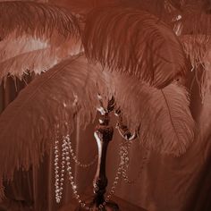 a vase filled with lots of feathers on top of a table