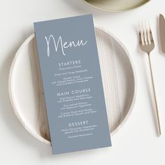 a menu card sitting on top of a white plate next to silverware and utensils