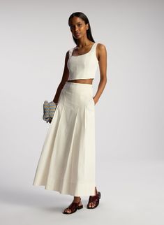 The Isabel Top is crafted from our compact linen stretch fabric in timeless white. This scoop neck top features a cropped length and visible seams that accentuate the body’s natural curvature. This style runs true to size. Shop Tops. Styling Tip: Style with the coordinated Eve Skirt and finish with strappy heels for effortless polish. Linen Skirt Outfit Summer, All White Outfit Ideas, Linen Skirt Outfit, Linen Skirt Set, Skirt Outfit Summer, Linen Fashion, All White Outfit, Shop Tops, Scoop Neck Top