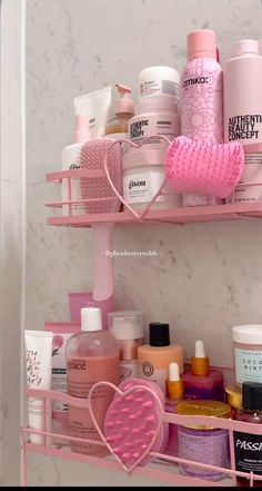 two pink shelves holding beauty products in a bathroom